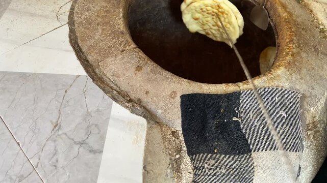 Person Cooking Naan in Tanoor Multan Pakistan