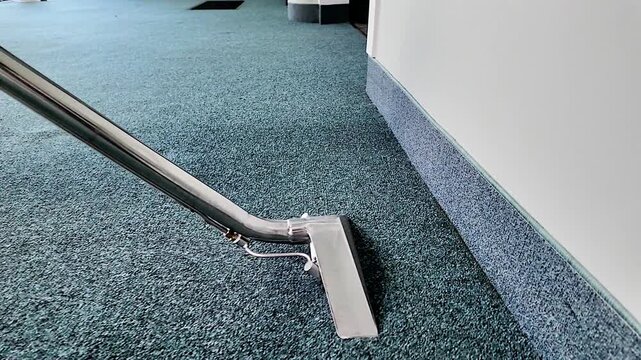 Carpet cleaning wand gliding across the carpet