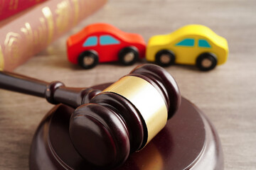 Car accident lawsuit and insurance, Judge hammer with car model.