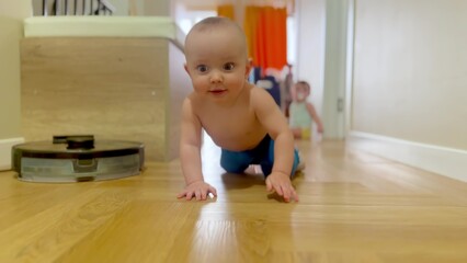 baby crawling on the floor twins play having fun. happy family child dream concept. baby boy fun crawling on the floor in the hallway first steps. baby twins crawls plays at home lifestyle