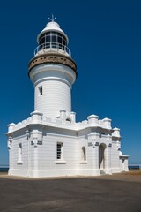 Byron Bay Lighthouse on a clear blue sky. Sunny day at Cape Byron. Beautiful old white lighthouse on the east coast of Australia. 
