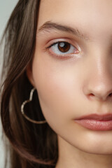 Obraz premium Close Up of a Woman's Face With Brown Eyes