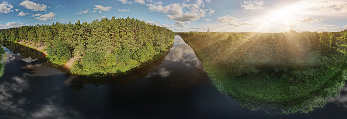 Drone view of the forest and fields, top view and blue sky on a sunny summer day