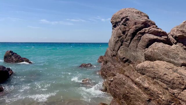 View of the Bay of Cannes with red rocks of Cap Esterel, Cannes, Cte d Azur, France. Cannes beach - France, Provence-Alpes-Cote d'Azur, View from beach to yachts in the evening. View of sea