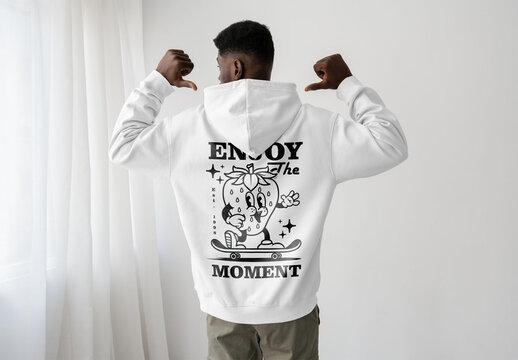 Mockup Of Man Wearing Customized Hoodie, Pointing, Rear View