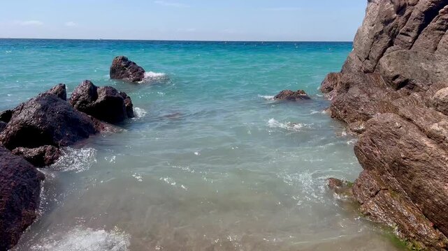 View of the Bay of Cannes with red rocks of Cap Esterel, Cannes, Cte d Azur, France. Cannes beach - France, Provence-Alpes-Cote d'Azur, View from beach to yachts in the evening. View of sea