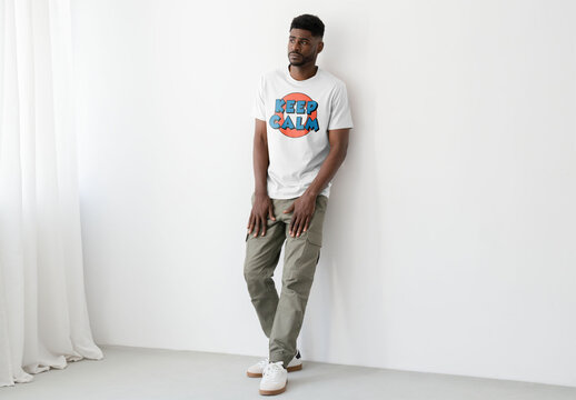 Mockup Of Man In Customized T-Shirt Against Wall, Full Length