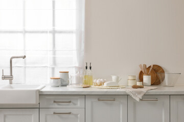 Fototapeta premium Stylish kitchen interior with beige wall. Space for text