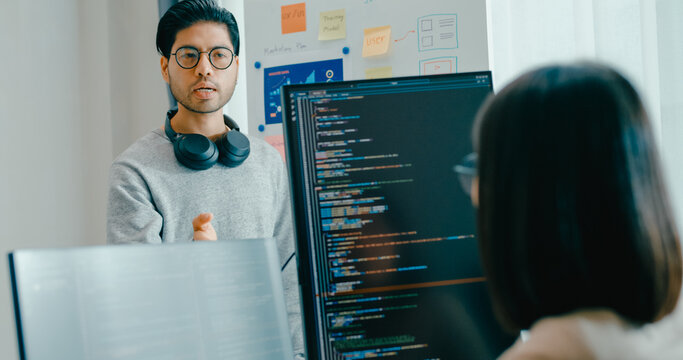 Group adult Asia male female software developers mentor leader manager talk strategy plan to executive write prompt AI bot IT app program nomad, video game, data center. Whiteboard slideshow code.