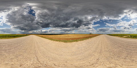 360 hdri panorama on roadside of gravel road with rain storm clouds in thunderstorm front dark sky in equirectangular spherical . seamless projection, as skydome replacement in drone panoramas