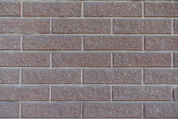 Close shot of pink split face brick veneer wall with stretcher bond pattern