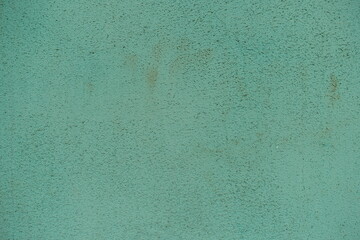 Close shot of old and faded turquoise painted wall