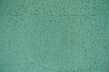 Obraz premium Close view of dirty and weathered pale turquoise painted wall