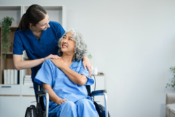 Fototapeta premium Elderly care concept. Portrait of nurse and her senior client on wheelchair.