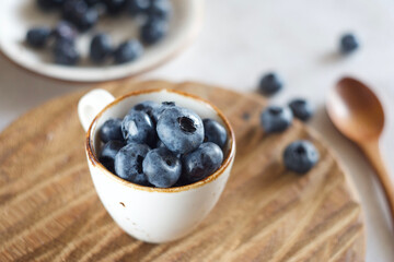 Blueberries in a mug on the table