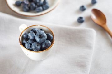 Blueberries in a mug on the table