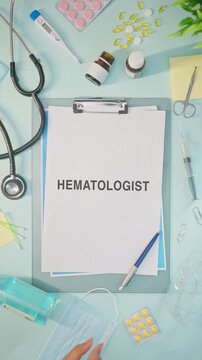 VERTICAL VIDEO OF HEMATOLOGIST WRITTEN ON MEDICAL PAPER