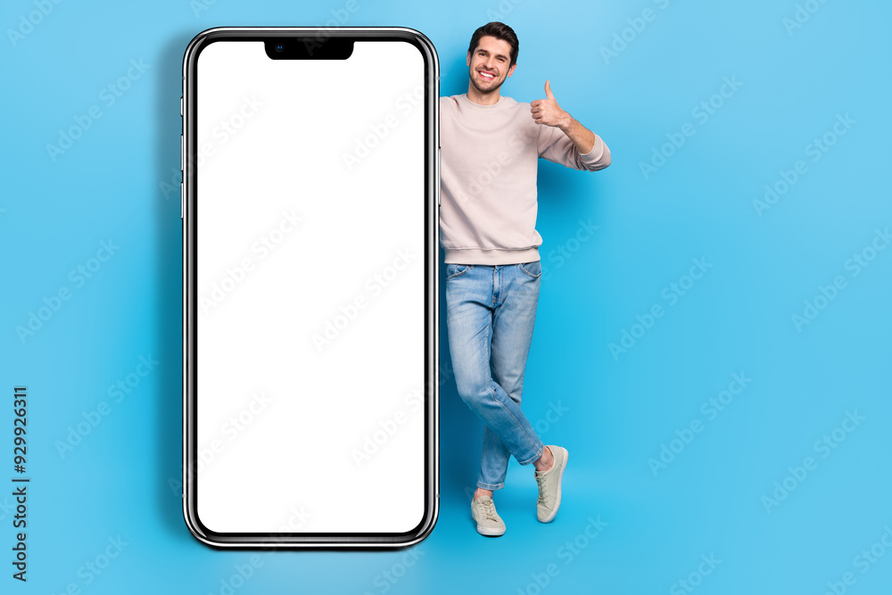 Poster full length photo of nice guy dressed white pullover hand on smart phone touchscreen showing thumb u