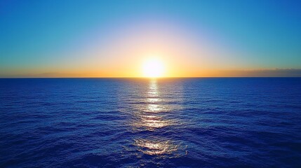 Obraz premium A beautiful blue ocean with a sun setting in the background 
