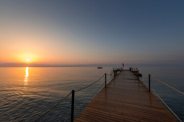 Fototapeta premium A pier with a dock and a boat in the water