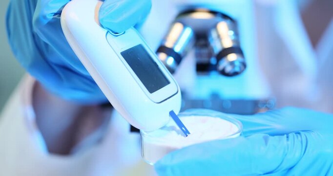 Laboratory assistant using a glucometer in laboratory
