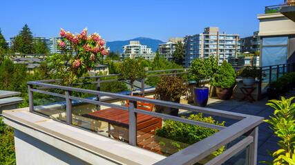 UniverCity Highlands, BC, aerial summer cityscape as seen from a neighborhood patio garden.