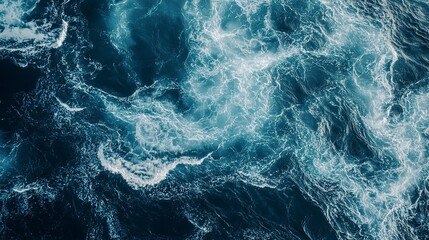 Fototapeta premium A top down view of ocean waves creating water patterns suitable as a background image with copy space
