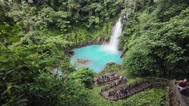 Tourists visiting the Rio Celeste Waterfall in Tenorio Volcano National Park of Costa Rica