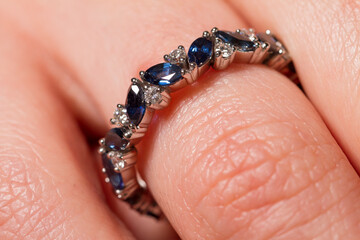 Macro shot of a jewel ring on a female hand.