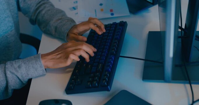 Closeup young adult Asia male freelance typing write prompt AI bot IT app smart program nomad, video game, terminal with coding language, designer, big data center on desktop computer in night office.