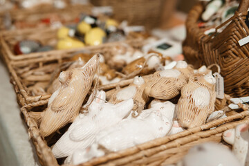 Sale of handmade ceramic Christmas tree toys at the Christmas Fair. Black Friday for the winter holidays.