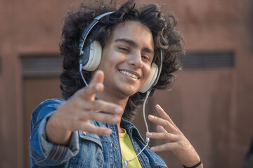 African American man with headphones dancing urban dance on the street