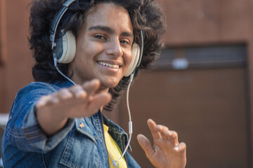 African American man with headphones dancing urban dance on the street