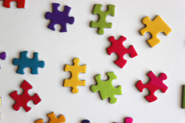Colorful jigsaw puzzle pieces on white background. Flat lay.