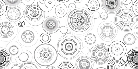 A grayscale pattern featuring concentric circles in various sizes and shades
