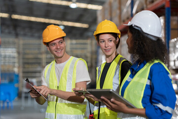 Warehouse worker working in warehouse. Male and female worker discussing at warehouse