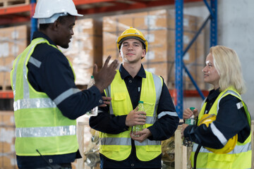 Warehouse worker working in warehouse. Male and female worker discussing at warehouse