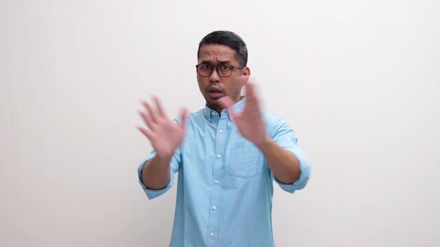 A man saying no and stop with scared expression