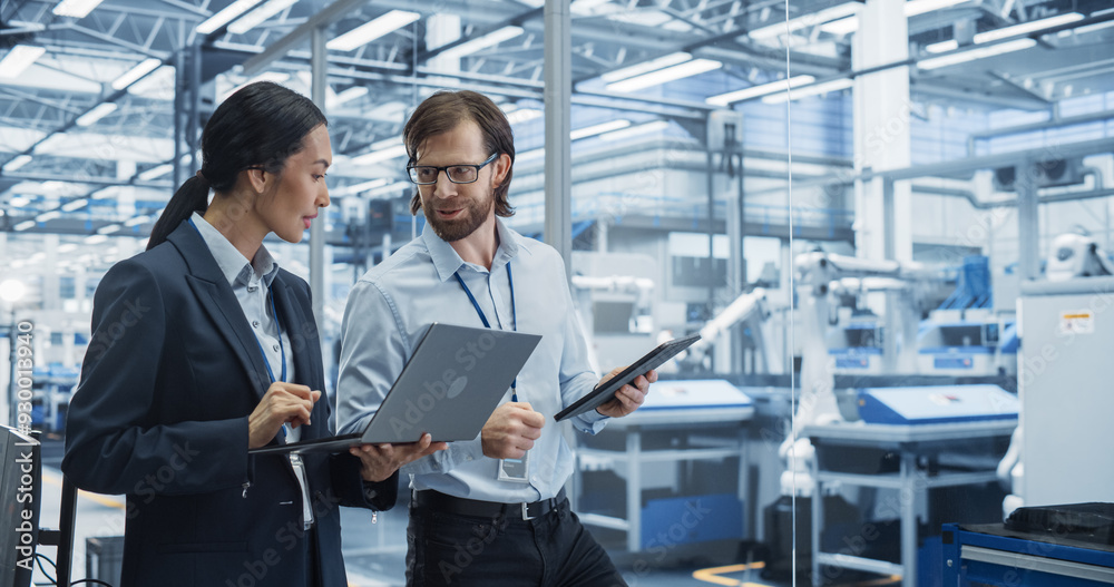 Poster Male Engineer and Female Project Manager Standing in Office, Talking, Using Computers and Monitoring Production at Modern Automated Electronics Manufacture with AI Robotic Arms