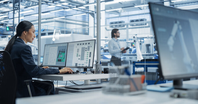 Asian Industrial Engineer Doing Creative Work on a Computer in Office. Intelligent Female Creating an Innovative Motherboard with Powerful Microchips for Artificial Intelligence Systems