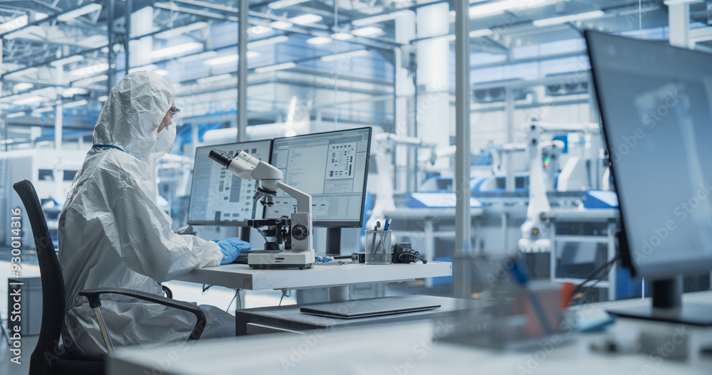 Aufkleber Modern Factory: Industrial Engineer Working on Desktop Computer in Clean Sterile Coveralls. Scientist Using a Microscope, Developing Advanced Solutions for High Tech Medical Vaccine and Gene Research