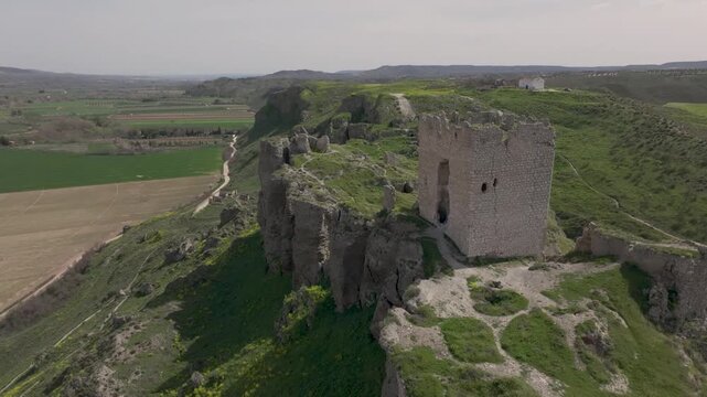 Spectacular flight with a drone in orbit at the end of the 9th century Oreja castle where its keep is located and the peak ending of the terrain and we appreciate the fall that it has