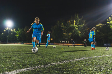 teenage girls playing football in the evening, practice for the school competition. High quality photo
