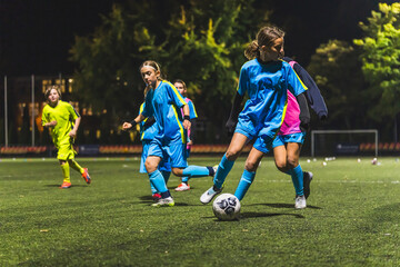 Kids play football on outdoor field. Children score a goal at soccer game, Sports training for player. High quality photo