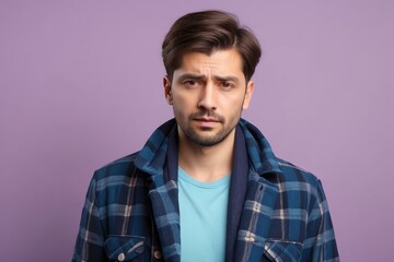 Fototapeta premium Young Man with Serious Expression in Plaid Shirt