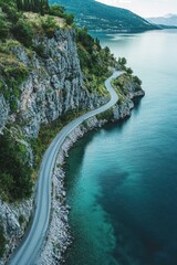 a winding road along a cliff beside a serene blue