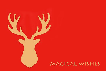 Magical wishes Christmas Eve gold reindeer decoration with text on red background. Fantasy concept symbol for the festive holiday season of Yule, Xmas, Noel, Copy space.
