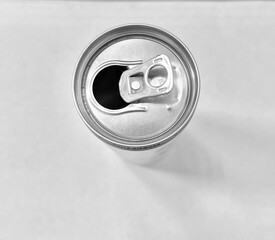 An aluminum can with a golden pull tab, already opened