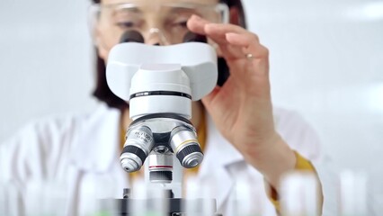 Woman scientist using microscope in laboratory. Microbiology science concept
