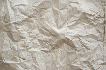 Craft crumpled paper, cardboard background. Brown kraft sheet texture, torn antique page, wallpaper or parchment abstract design, Horizontal rough carton